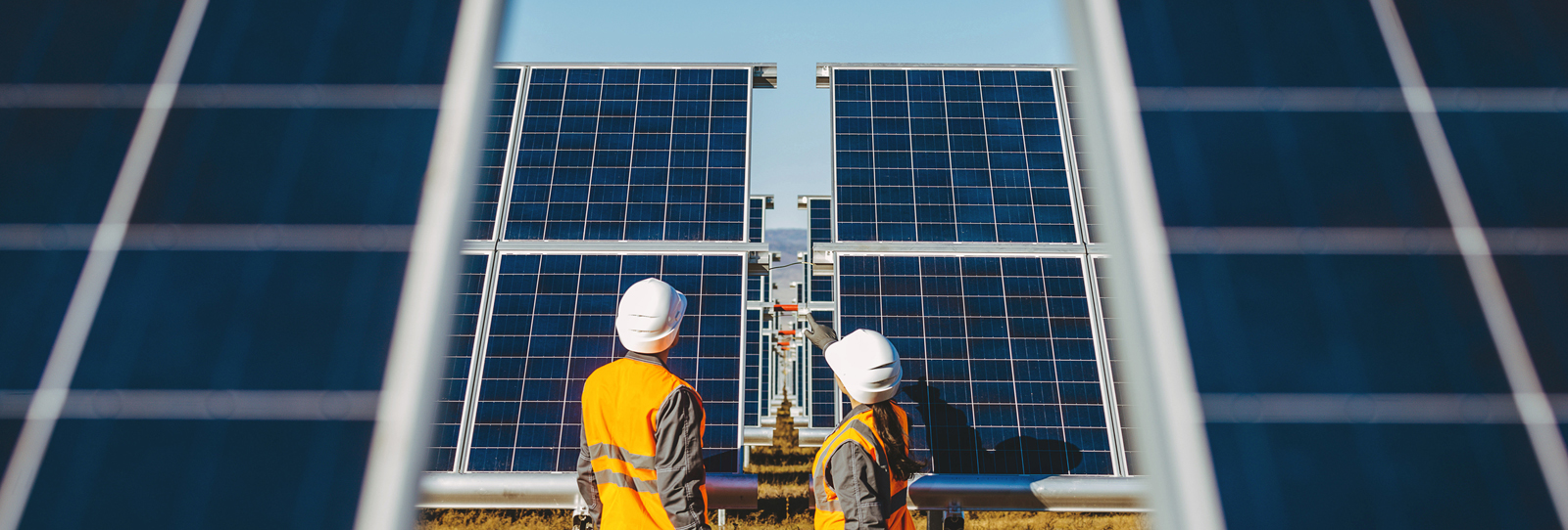 Solar panels and on-site personnel at a solar power plant